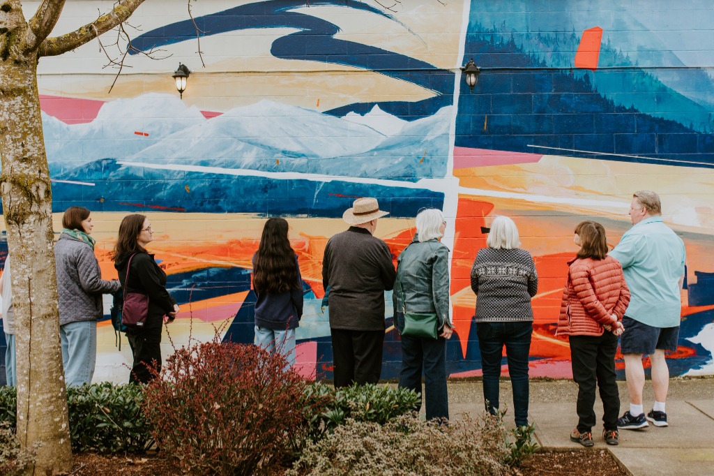 Tour group admiring Chilliwack's vibrant downtown murals